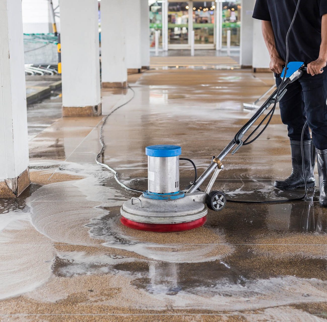 asian-worker-cleaning-sand-wash-exterior-walkway