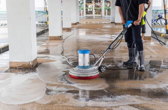 asian-worker-cleaning-sand-wash-exterior-walkway